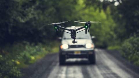 A drone flying flying over the road